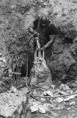 Concrete worker exposing rebar, August 1, 1994